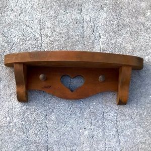 Very cute wooden shelf.  I am just redecorating. A few small black spots on top.